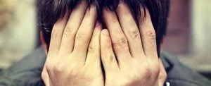 Person covering face with hands