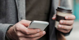 Person with phone and coffee